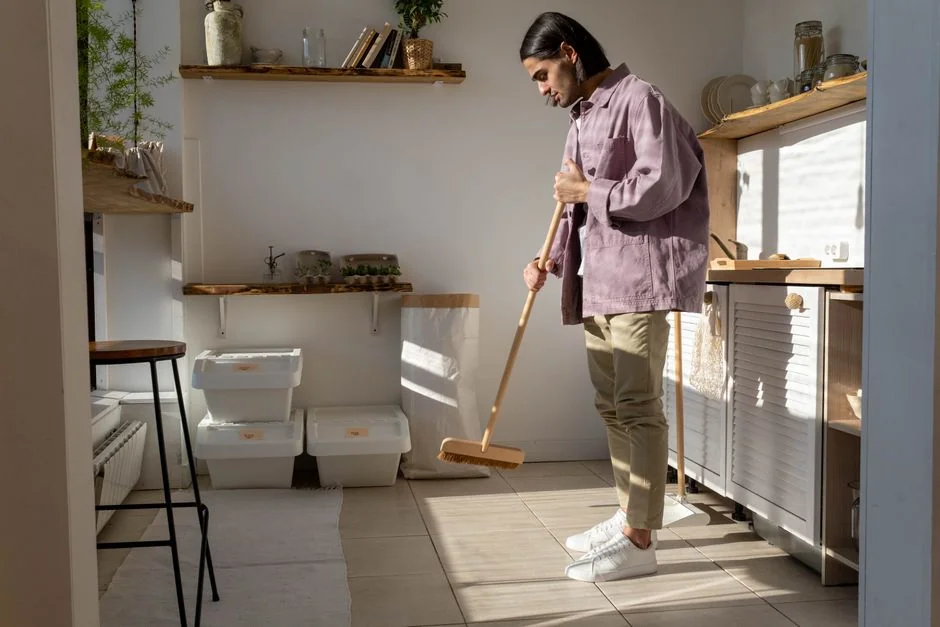 Cleaner using a vacuum in a stylish indoor setting, showcasing cleaning equipment and techniques.